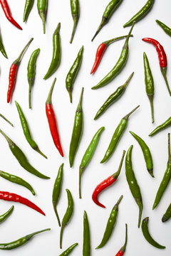 Red and green hot chilli pepper on white background