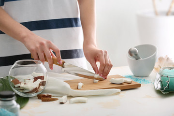 Obraz na płótnie Canvas Woman preparing body scrub at table