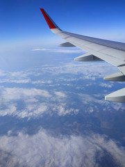 Beautiful view of airplane wing on blue sky background