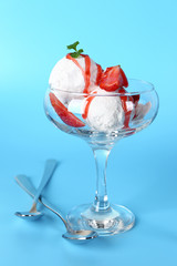 Glass bowl with tasty ice cream on color background