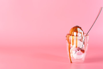 Glass with tasty ice cream on color background