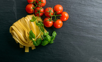 Raw yellow italian pasta pappardelle, fettuccine or tagliatelle