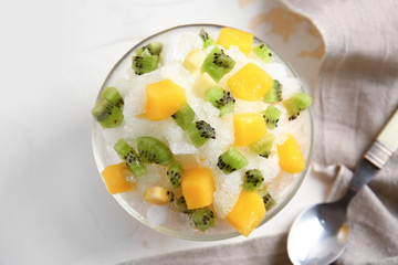 Bowl with tasty shaved ice on light table