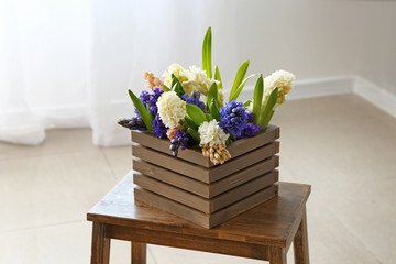 Box with beautiful hyacinth flowers on table