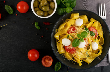 Yellow italian pasta pappardelle, fettuccine or tagliatelle
