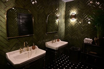 Toilet room with washbasins in a public place. Toilet room with washbasins of green color.