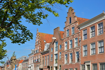 Fototapeta premium Traditional and colorful facades located along Spaarne river, with the Teylers Museum on the left, Haarlem, Netherlands