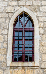 Fototapeta na wymiar Window in the wall of an old building in Dubrovnik.