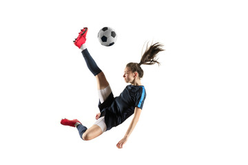 Young female football or soccer player with long hair in sportwear and boots kicking ball for the...