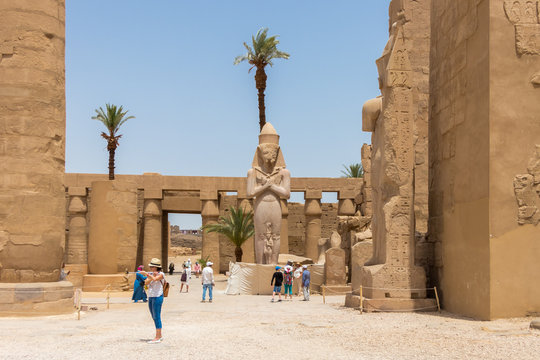 Luxor, Egypt - April 16, 2019: Statue of Ramesses II with his daughter, princess Bintanath, Luxor, Egypt