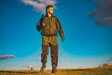 Hunter with shotgun gun on hunt. Hunter in the fall hunting season.