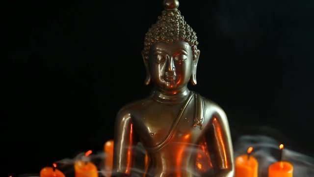Buddha statue and candle in the dark, Chiangmai Thailand