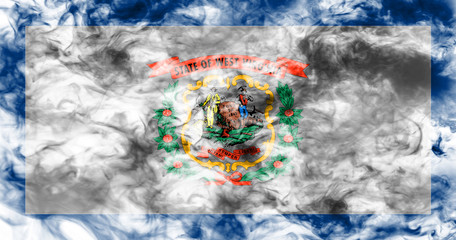 The national flag of the US state West Virginia in against a gray smoke on the day of independence in different colors of blue red and yellow. Political and religious disputes, customs and delivery.