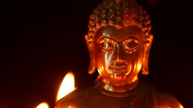 Buddha statue and candle in the dark, Chiangmai Thailand