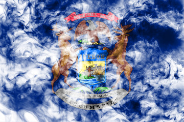 The national flag of the US state Michigan in against a gray smoke on the day of independence in different colors of blue red and yellow. Political and religious disputes, customs and delivery.