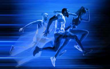 Young african-american and caucasian men and woman running isolated on blue studio background....