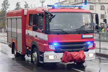 Fire brigade workers are riding fire truck on military parade
