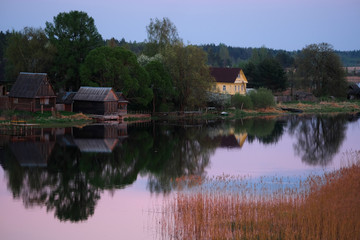 Fototapeta na wymiar Landscape with the image of village on lake Seliger in Russia