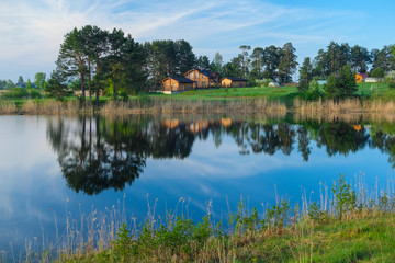Fototapeta na wymiar Landscape with the image of village Svetlitsa on lake Seliger in Russia