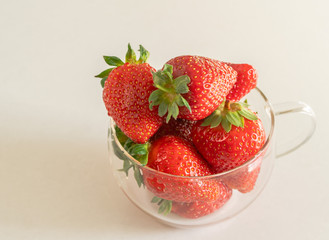 strawberries in a glass on a white background