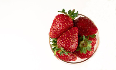 strawberries in a glass on a white background