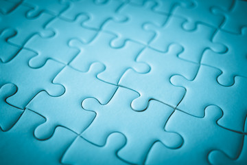 Fototapeta premium macro shot of white plain jigsaw, step of success concept