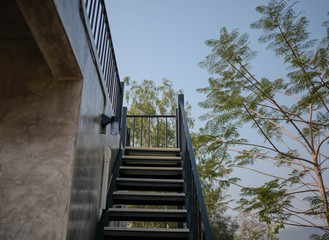 Obraz premium Stainless steel stairs outside the building with concrete wall.