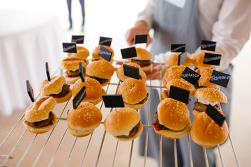 waiter serving lamb burgers
