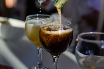 Waiter serving sodas in a cup