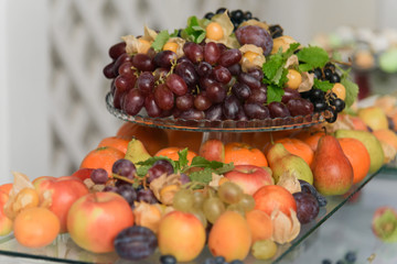 Obraz na płótnie Canvas Catering service, fruits and berries on a stand close up