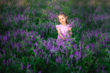 Fototapeta na wymiar portrait smiling toddler girl in lavender field