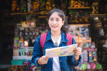 Young asian girl walking at Dumonoe saduak floating market, Thailand