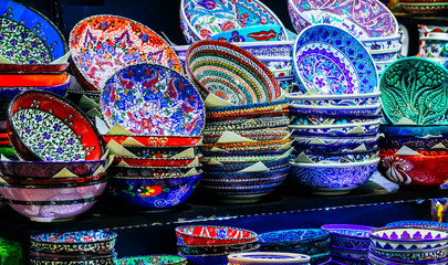 Traditional Asian oriental ceramic bowl plates, souvenir shop showcase on grand bazaar. Colorful dishes with Turkish floral decoration ornament.