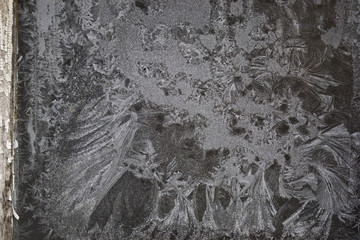  Crystal patterns on the glass in the frosty winter