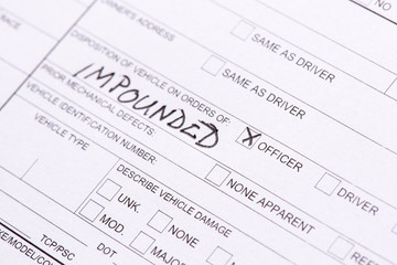 A close up of a traffic collision report where a car was impounded.