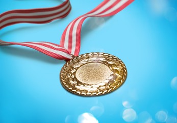 Gold medal with red white ribbon on blue background