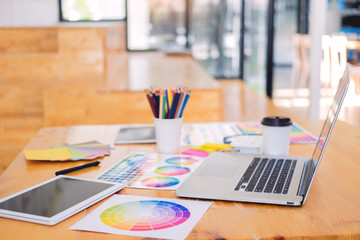 team interior designer drawing a new project using graphic computer and choosing Color swatch samples in modern Creative studio.