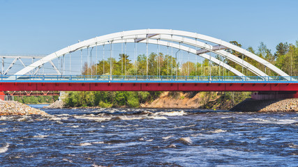 road bridge over a fast bubbling river in natural light.
