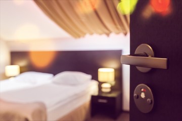 Open door to a spacious bedroom in the hotel