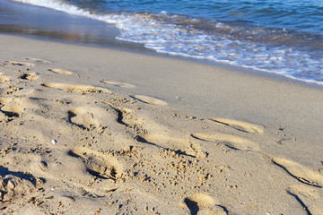 footprints barefoot on a sandy beach on the shores of the Mediterranean