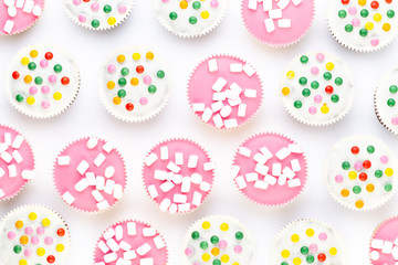 Colorful cupcakes on a white background.