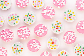 Colorful cupcakes on a white background.