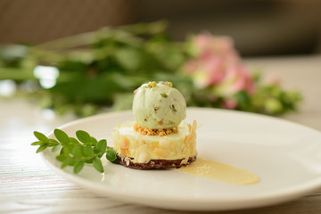 Obraz na płótnie Canvas dessert with a ball of pistachio ice cream with flower decor