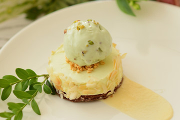 dessert with a ball of pistachio ice cream with flower decor