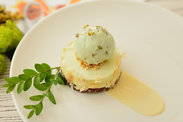 dessert with a ball of pistachio ice cream with flower decor