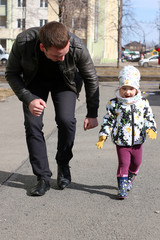 dad and daughter dabble and run on a spring walk