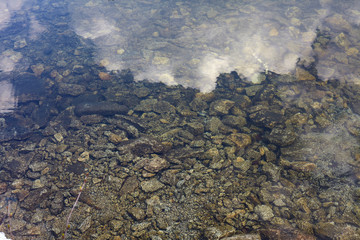 Fototapeta na wymiar Stones under the water on the lake.