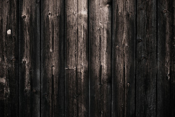 Fototapeta na wymiar Dirty dark shabby wooden table. Black wooden fence texture background. Wood pattern, surface. Old wall wooden vintage floor. Close-up of wooden black board texture.