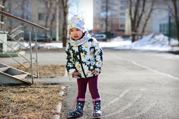 beautiful little girl on a walk in early spring