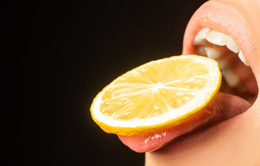 Lemon taste. Lemon slice on womans tongue. Open mouth with sour taste. Cocktail in the summer. Open...